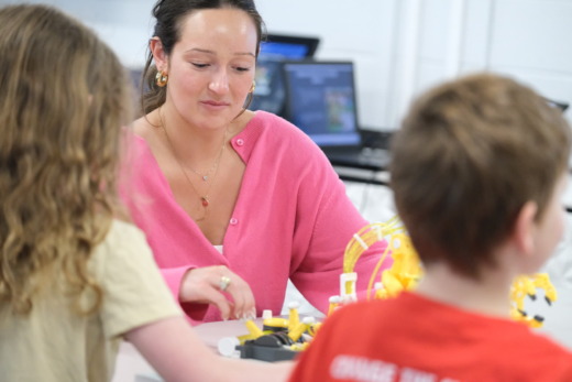 MAT student works on robotics project with young children