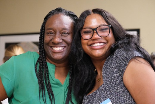 Two women pose for photo together