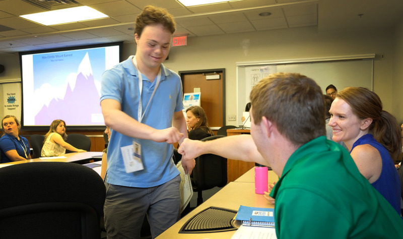 Two students fist-bumping