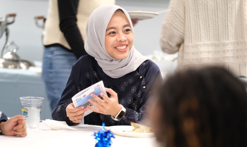 School counseling student talking with classmate.