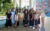 Group photo of school counseling cohort in front of the old well.