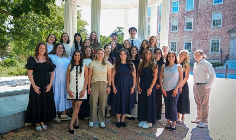 Group photo of school counseling cohort in front of the old well.