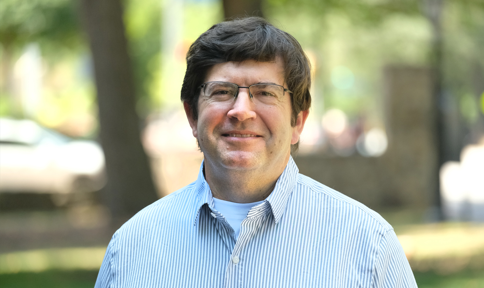 Portrait of faculty member Roger Mills-Koonce outdoors on the UNC-Chapel Hill campus.
