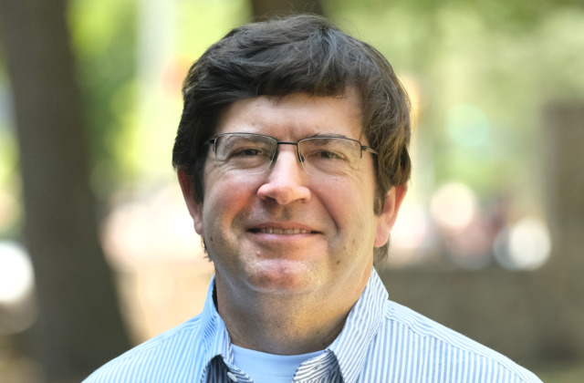 Portrait of faculty member Roger Mills-Koonce outdoors on the UNC-Chapel Hill campus.
