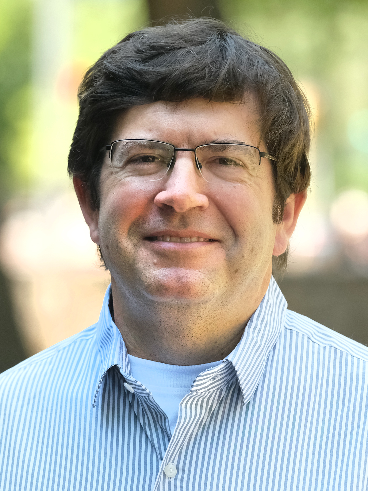 Portrait of faculty member Roger Mills-Koonce outdoors on the UNC-Chapel Hill campus.