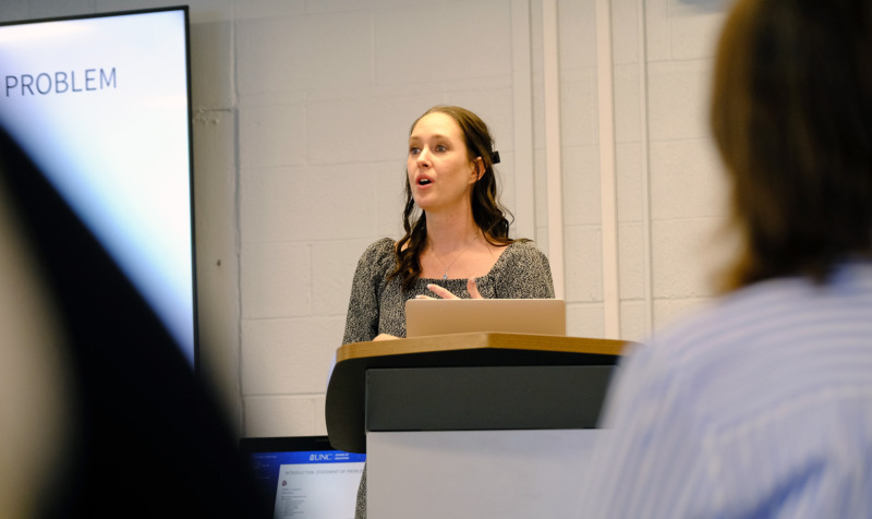 Photo of Ph.D. student presenting research in Peabody Hall on the UNC-Chapel Hill campus.