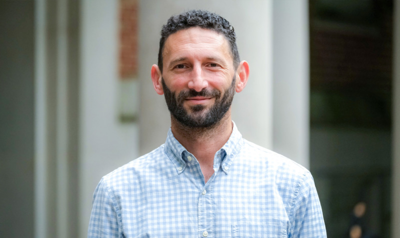 Portrait of faculty member Ethan Hutt outdoors on the UNC-Chapel Hill campus.