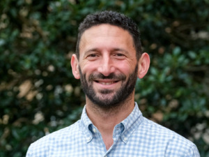 Portrait of faculty member Ethan Hutt outdoors on the UNC-Chapel Hill campus.