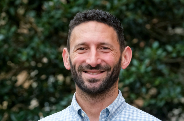 Portrait of faculty member Ethan Hutt outdoors on the UNC-Chapel Hill campus.