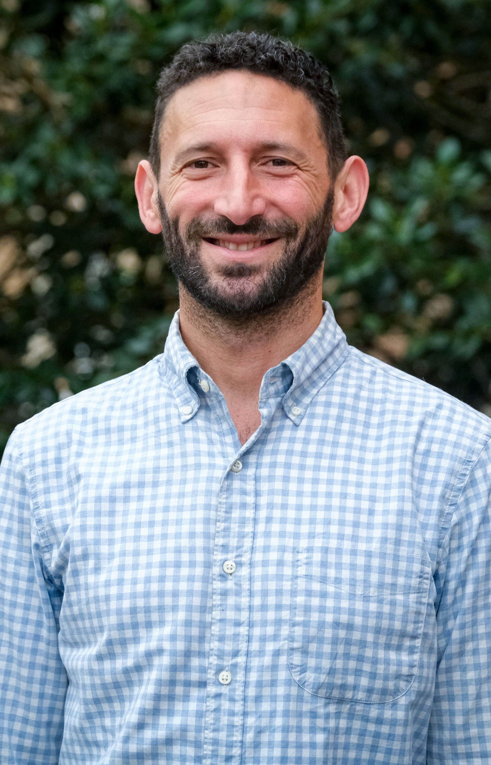 Portrait of faculty member Ethan Hutt outdoors on the UNC-Chapel Hill campus.