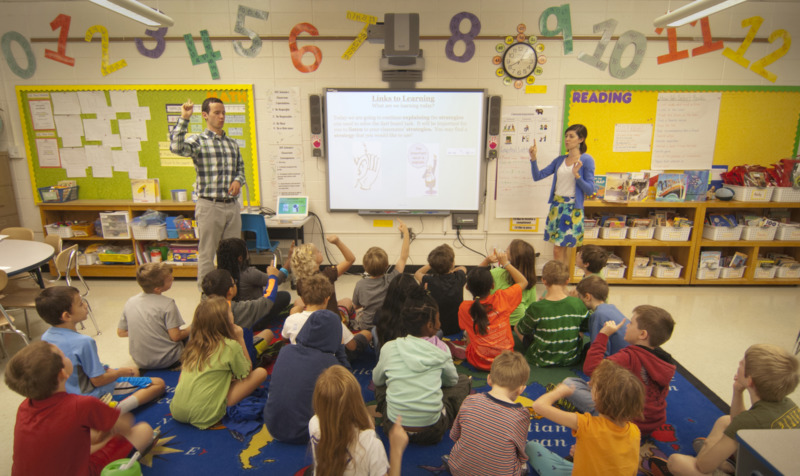 students teaching an elementary class