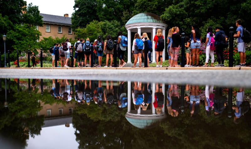 students lined up to sip from the old well