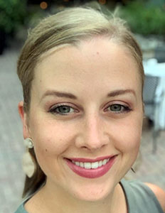 Portrait of Ashley Cates. Ashley is a white woman with blond hair. She is smiling at the camera.