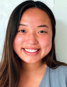 Portrait of Janice Yang Thomas. Janice is an Asian woman with straight brown hair. She is wearing a blue shirt and smiling.