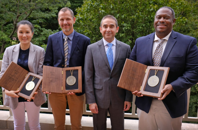 Group of five, with four holding professorship medallions