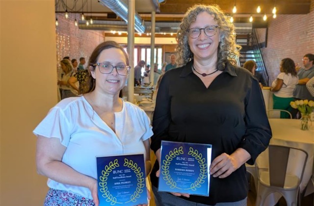 2025 Staff Excellence Award recipients Barbara Bossen (right) and April Plumley (left) at the UNC School of Education’s end-of-semester celebration on May 8.