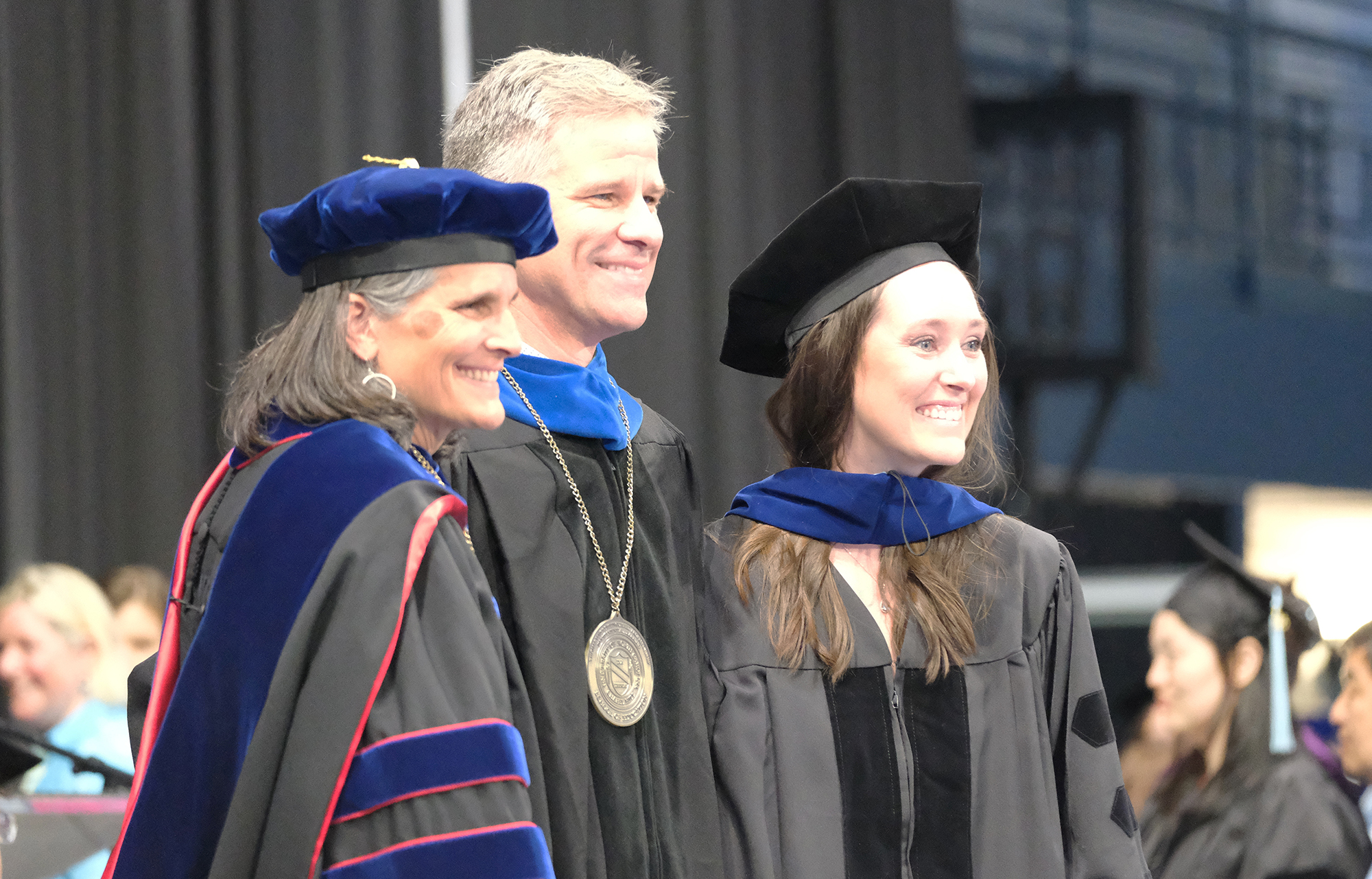 Troy Sadler, center, poses with Dean Jill V. Hamm, left, and Ph.D. graduate Rebecca Lesnefsky at the UNC School of Education graduation ceremony on Saturday, May 10, 2025, in Carmichael Arena.