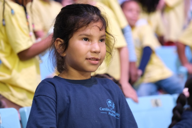 CCA student cheers at a UNC Women's Basketball game.
