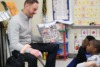 Faculty member Chris Scott, Ed.D. leads an interactive reading session with CCA students.