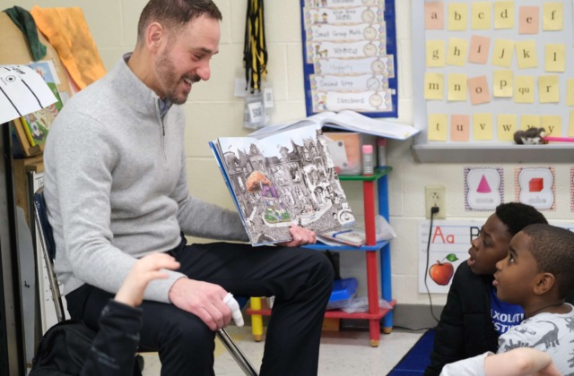 Faculty member Chris Scott, Ed.D. leads an interactive reading session with CCA students.