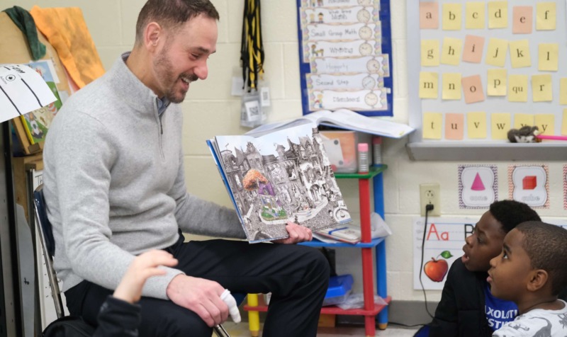 Faculty member Chris Scott, Ed.D. leads an interactive reading session with CCA students.