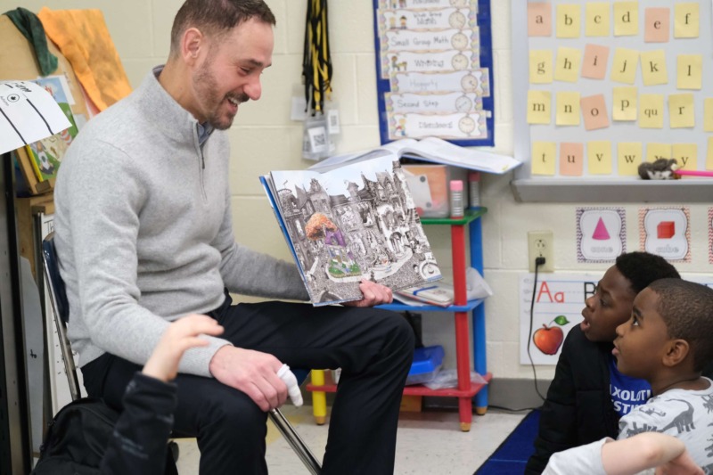 Faculty member Chris Scott, Ed.D. leads an interactive reading session with CCA students.