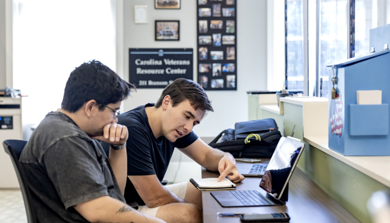 Two students working together at a computer in the Carolina Veteran Resource Center.