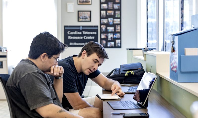 Two students working together at a computer in the Carolina Veteran Resource Center.