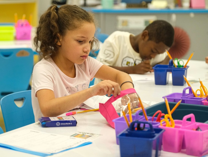 Students work together on a project during the first day of school.