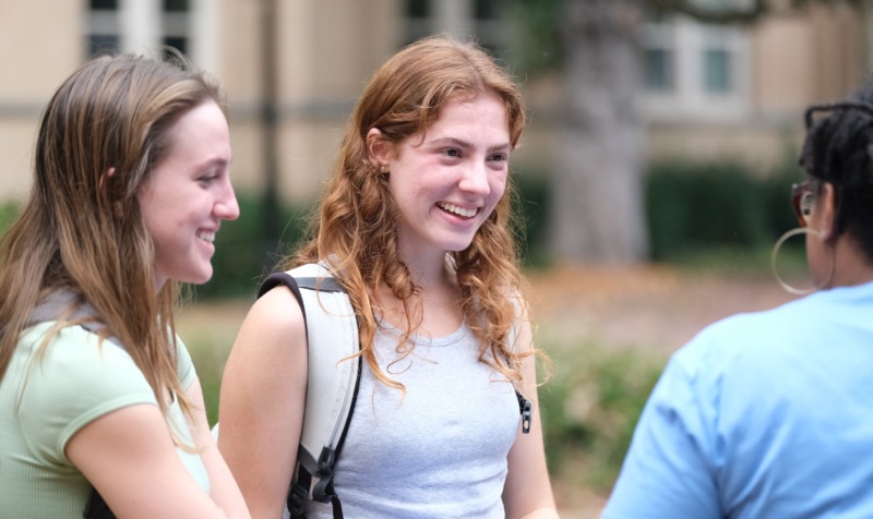 Students talk outside Peabody Hall at UNC-Chapel Hill.