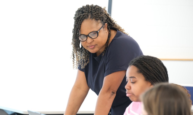 HDFS faculty member Helyne Frederick works with students in class.