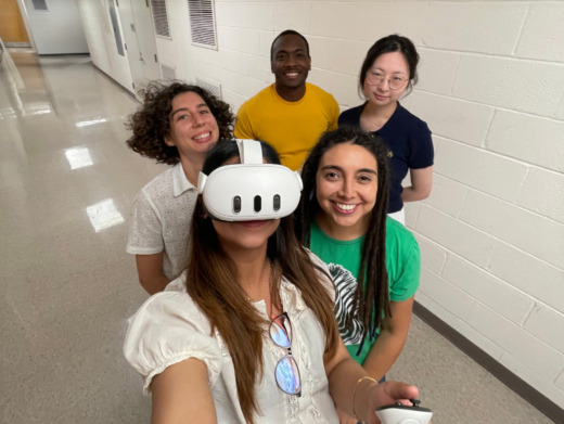 students pose for selfie in VR glasses