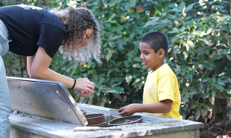 Lexi Bravo with a student during a CCA field trip.