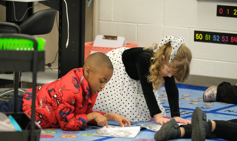Two CCA students reading together