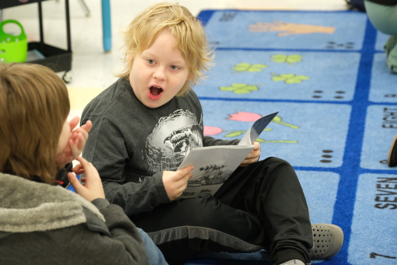 CCA student excited while reading a book