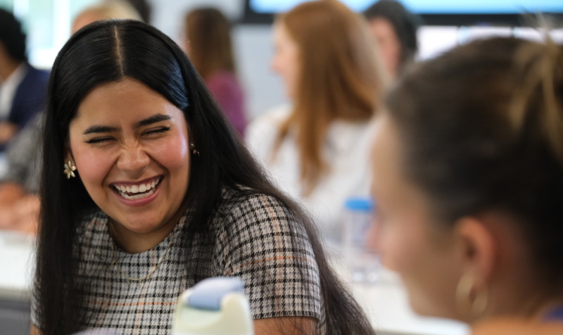 Two students laughing together in class