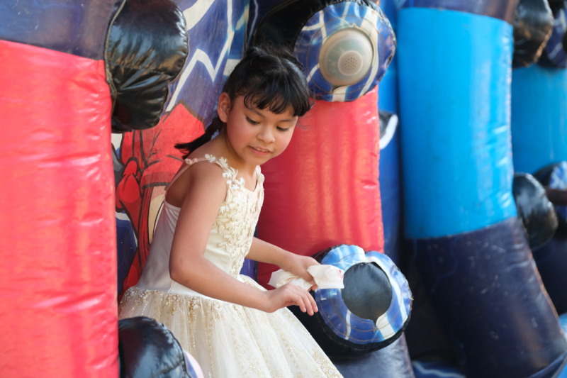CCA student plays on bounce house at second grade cookout