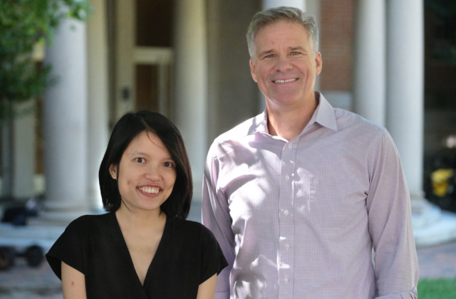 Image of Ha Nguyen, left, and Troy Sadler, right, in front of Peabody Hall on the University of North Carolina at Chapel Hill campus