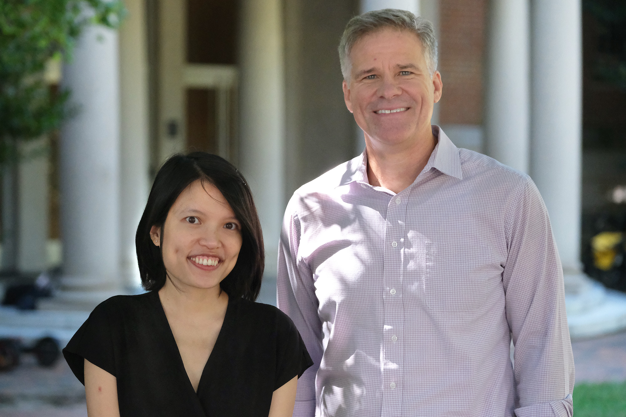 Image of Ha Nguyen, left, and Troy Sadler, right, in front of Peabody Hall on the University of North Carolina at Chapel Hill campus