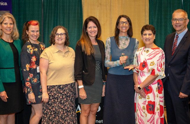 Image of seven people from the UNC School of Education, NC State College of Education, and CAEP at an award presentation of the Frank Murray Leadership Recognition for Continuous Improvement