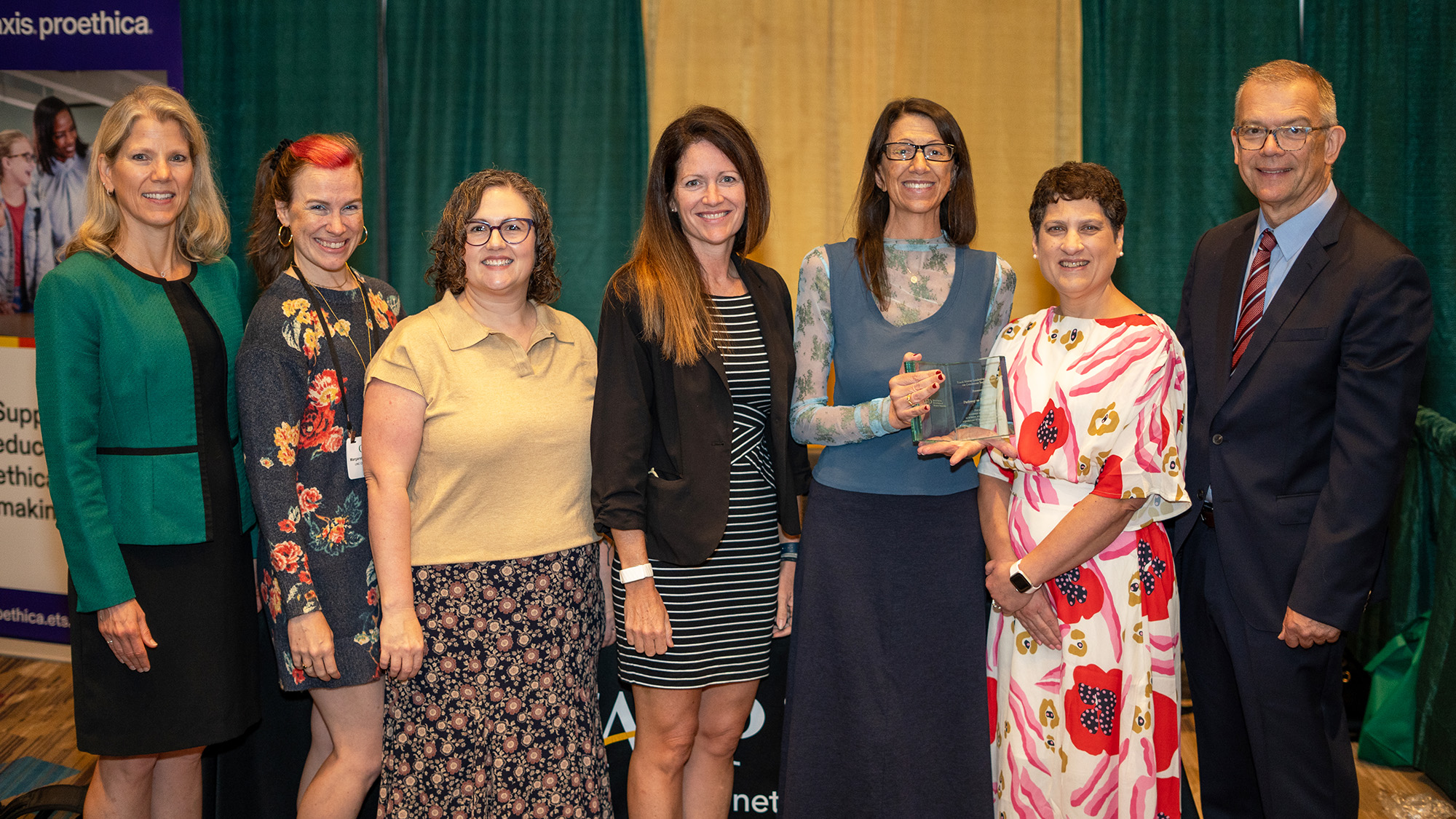 Image of seven people from the UNC School of Education, NC State College of Education, and CAEP at an award presentation of the Frank Murray Leadership Recognition for Continuous Improvement